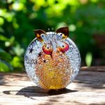 Ball urn and butterfly of cognac brown/ transparent glass.
