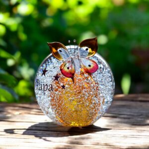 Ball urn and butterfly of cognac brown/ transparent glass.