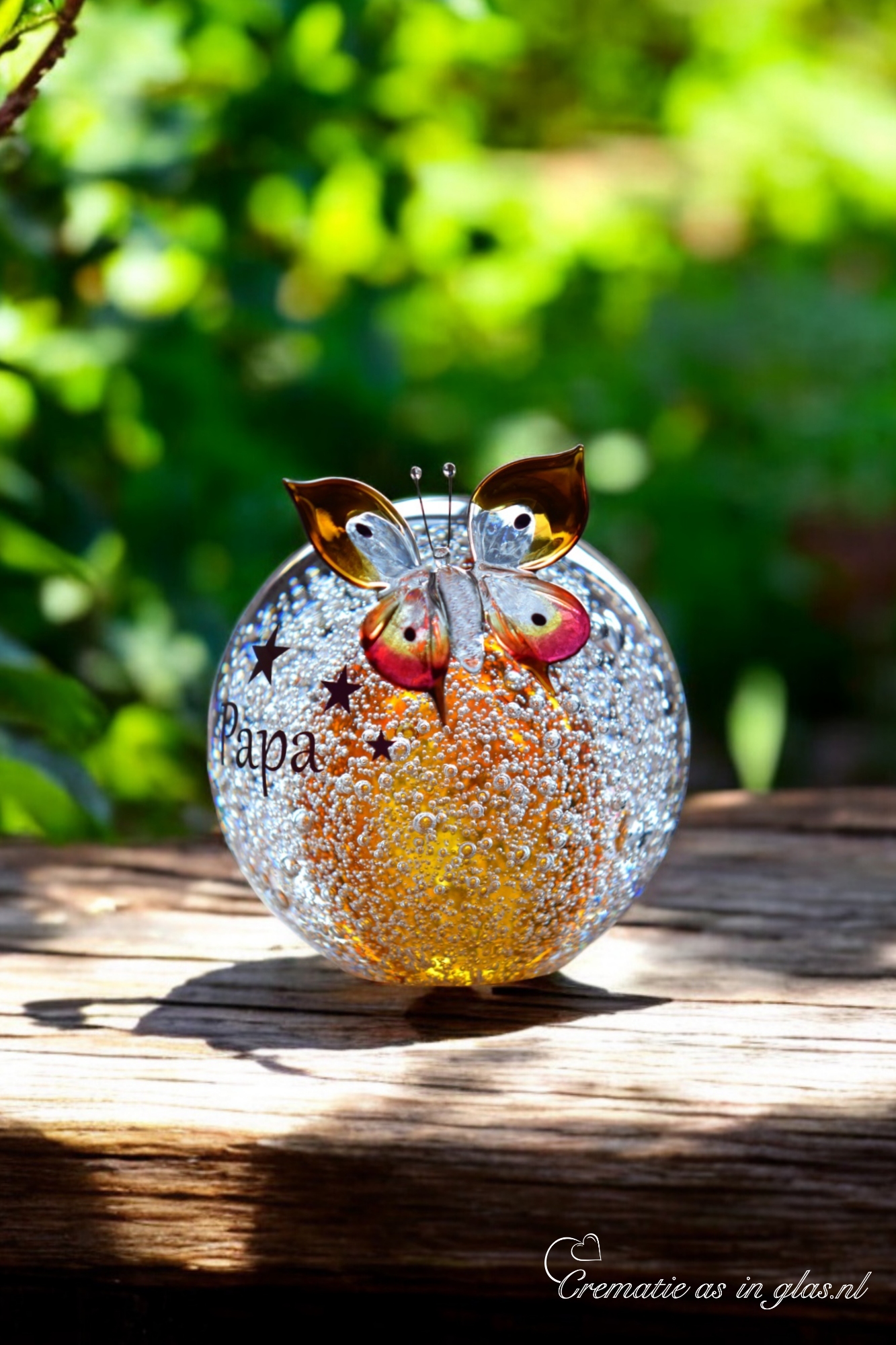 Ball urn and butterfly of cognac brown/ transparent glass.