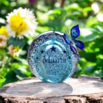 Ball urn and butterfly of blue transparent glass.