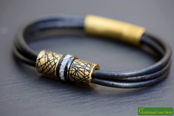 Memorial bracelet with stainless steel bead visibly containing cremation ashes