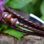 Brown leather memorial bracelet with transparent glass bead subtly containing cremation ashes
