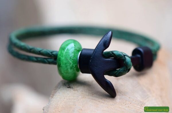 Green leather memorial bracelet with transparent glass bead visibly containing cremation ashes