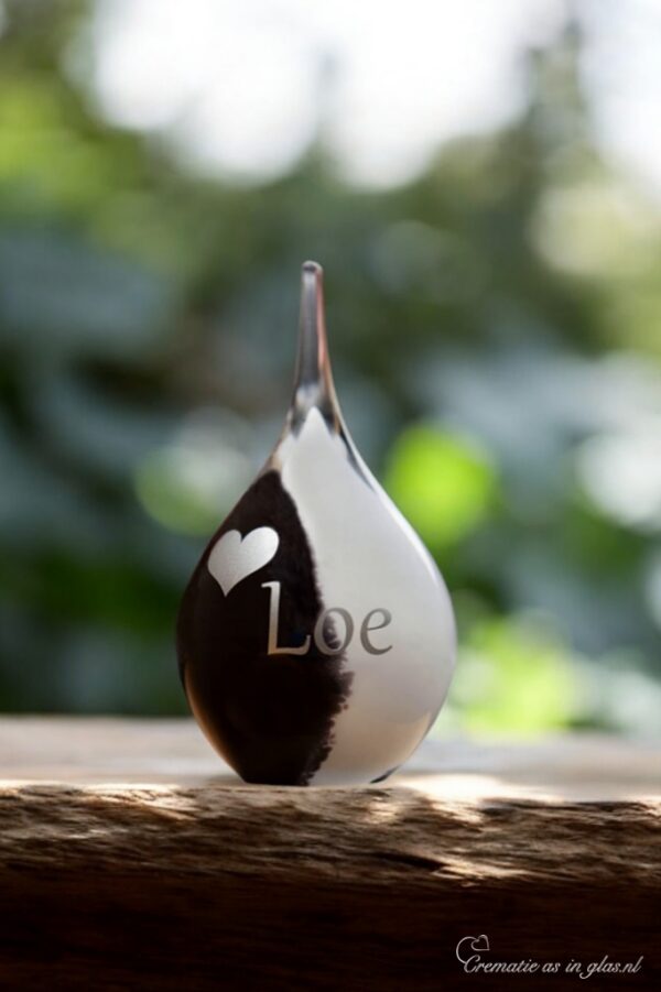 Small glass urn in black and white with silver foil heart and personalized name."