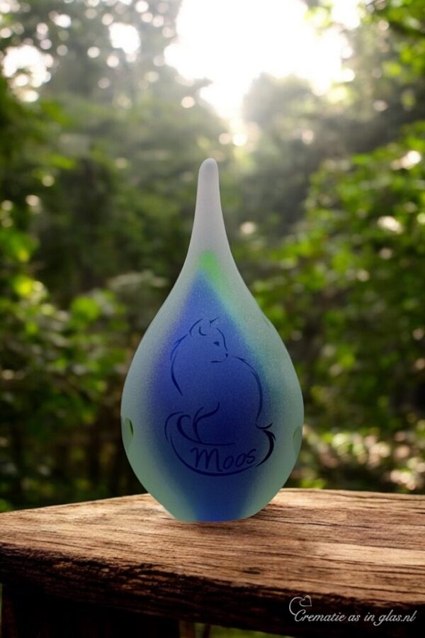 Small green and blue frosted glass urn with sandblasted cat illustration and name incorporated into the tail.