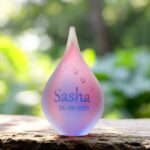 Small pink and blue frosted glass urn with sandblasted dog paw prints