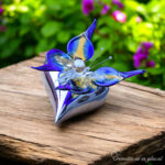 Yellow-blue glass butterfly on silver-colored heart