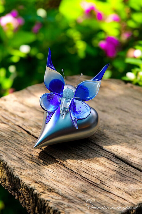 Blue glass butterfly on silver-colored heart