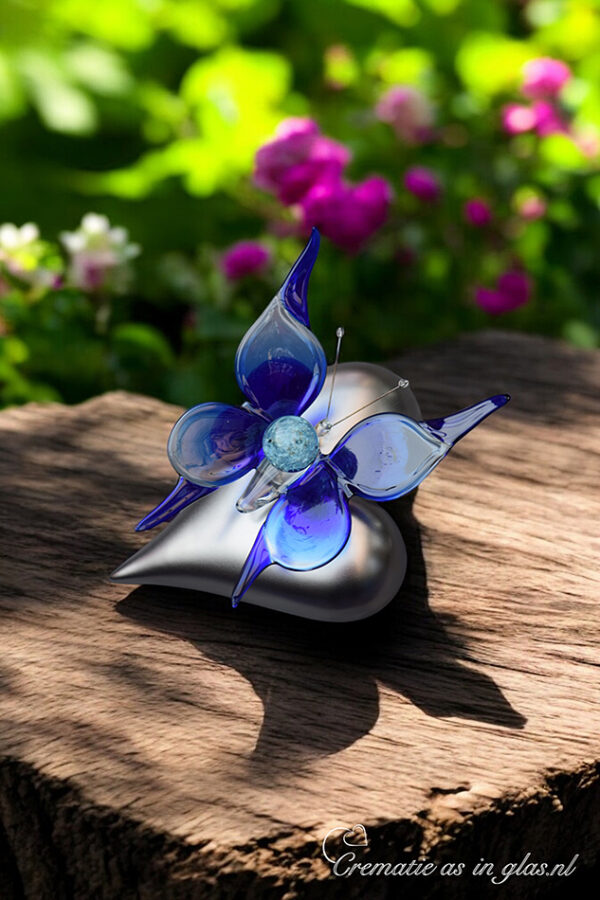 with mini urn showing cremation ashes fused visibly into the glass.