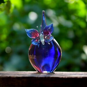 Urn and butterfly of pink and blue transparent glass.