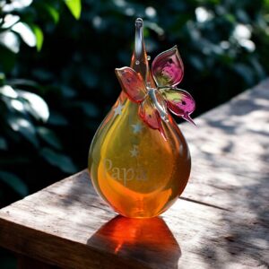 Urn and butterfly of pink and yellow transparent glass.