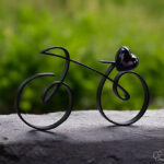 Elegant black metal racing bike with a black-transparent glass heart on the saddle