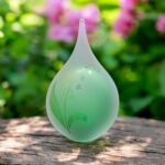 Urn of green glass. Cremation ash urn glass personalized to keep as a precious memory