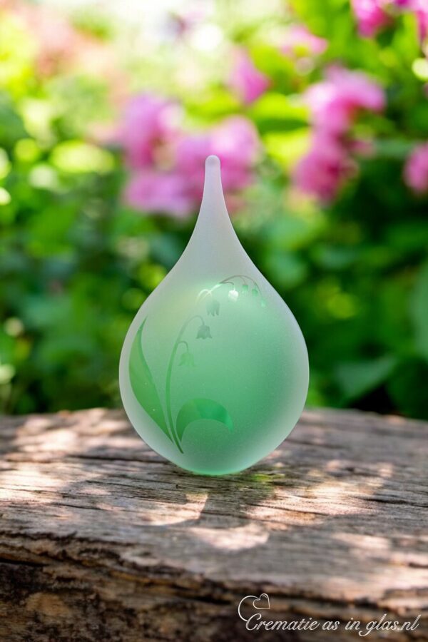 Urn of green glass. Cremation ash urn glass personalized to keep as a precious memory