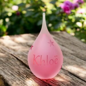 Urn of pink glass. Cremation ash urn glass personalized to keep as a precious memory