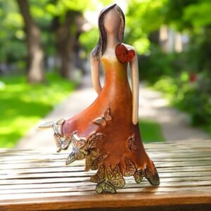 Ceramic sculpture of a woman with butterfly dress