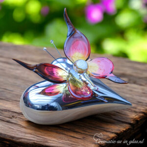 Red-yellow glass butterfly with brown detail on silver-colored heart