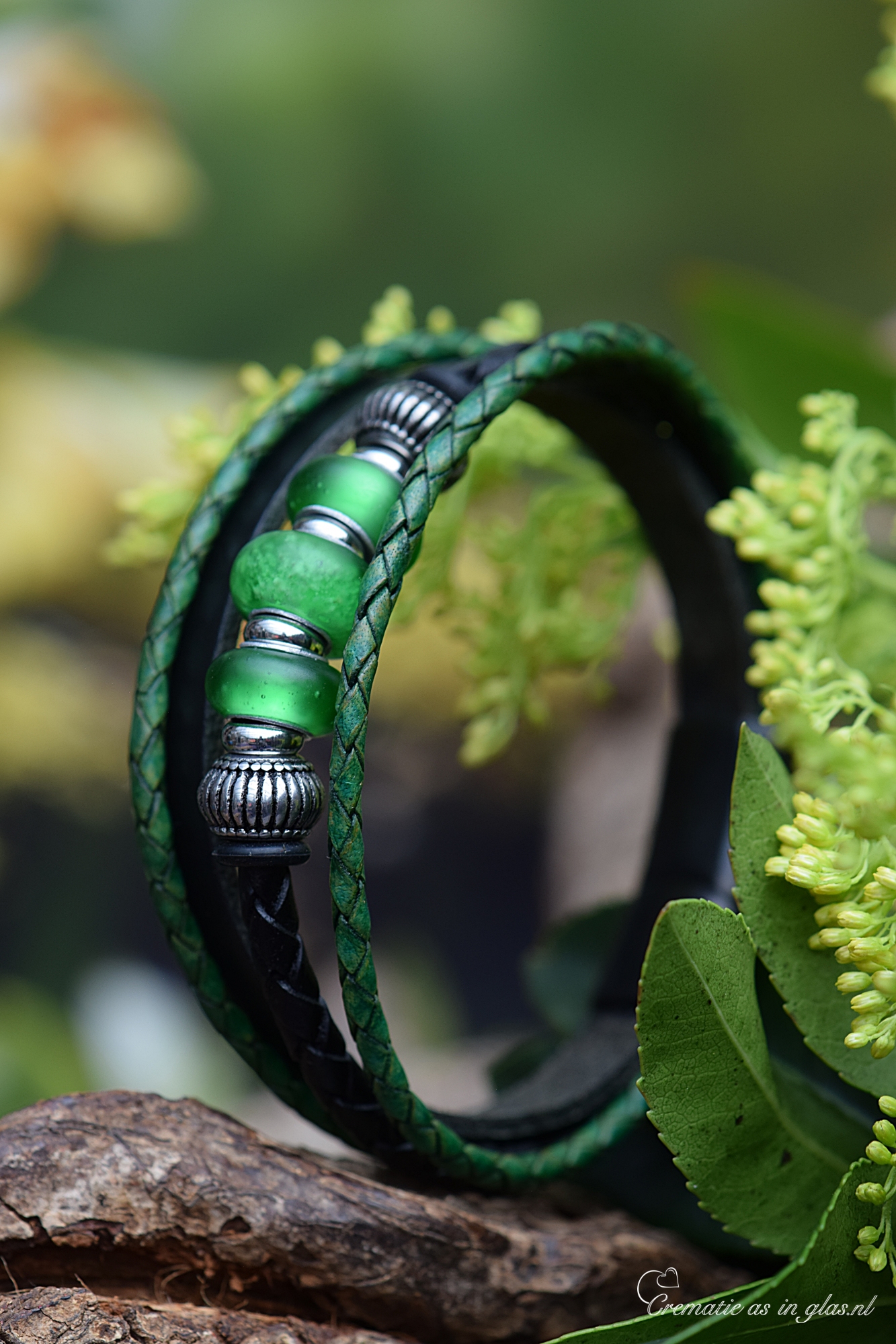 Men’s leather memorial bracelet with green glass beads, featuring cremation ash fused into the center bead.