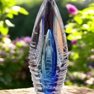 Design urn made of glass with transparent tone-on-tone blue ash chamber and 3D lines of molten glass over the urn – suitable for cremation ashes.