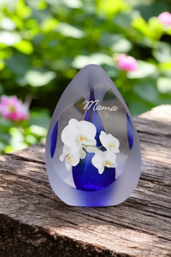 Design urn made of glass with transparent blue ash chamber and image of a white orchid – suitable for storing cremation ashes.