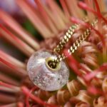 Glass&Golds Purity transparent cremation bead with visible ashes and 14k gold core on 45 cm gold chain.