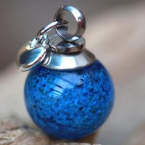 Memorial pendant with ashes in blue glass