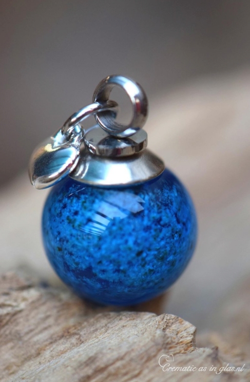 Memorial pendant with ashes in blue glass
