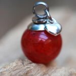 Memorial pendant with hidden ashes in red glass