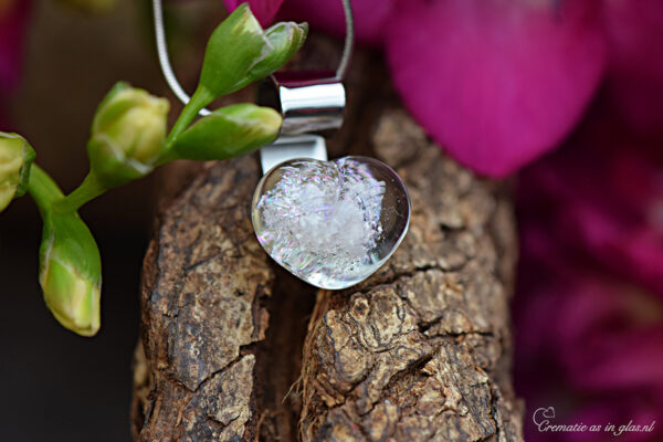 Glass heart pendant with visible ashes in transparent multicolor shimmering glass and 925 sterling silver bail.
