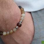Men’s memorial bracelet with brown banded agate beads and non-visible ashes in a matte brown glass bead.