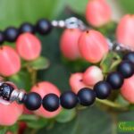 Men’s memorial bracelet with black onyx beads and semi-visible ashes in a black transparent glass bead.
