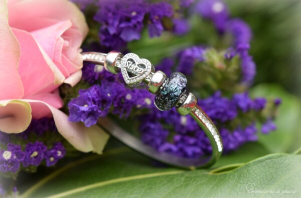 Memorial bangle with invisible ashes in black shimmer glass and sterling silver ‘Sister’ charm