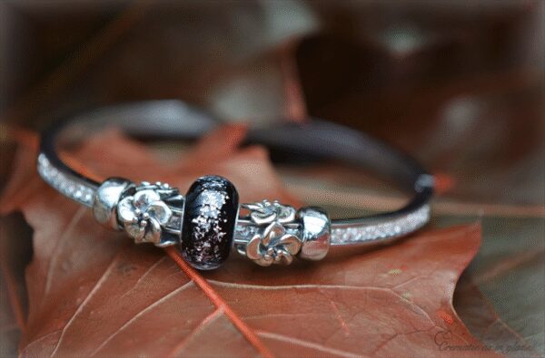 Elegant memorial bangle with invisible ashes in black and silver shimmer glass