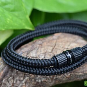Black men’s memorial bracelet with central stainless steel bead containing cremation ashes.