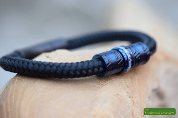 flanked by two dark blue design beads.