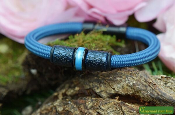 Bracelet with dark blue stainless steel design beads and cremation ash bead on a black Sailrope band.