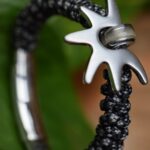 Men’s memorial bracelet in grey-black-white braided sailrope with stainless-steel sun pendant containing a hair lock