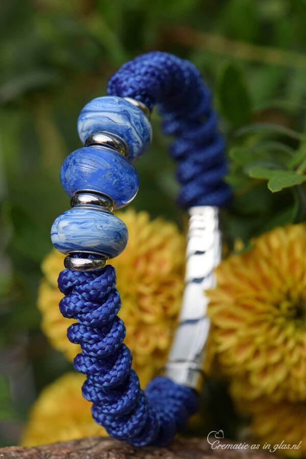 with cremation ashes in the center bead.