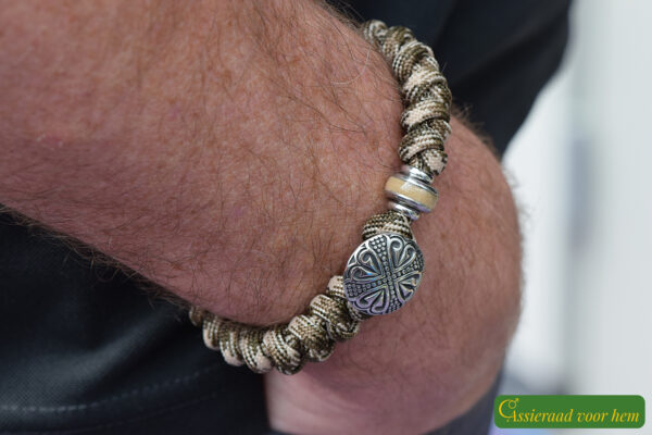 featuring a stainless steel bead containing cremation ashes and a decorative heart-pattern stainless steel bead.