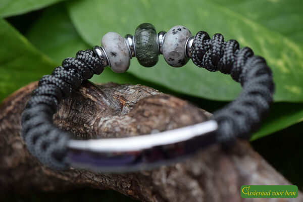 flanked by two marbled grey-blue beads.
