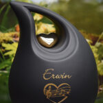 slanted tear urn in a black color with a gold heart