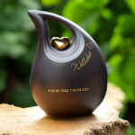 Slanted tear urn in black color with gold heart