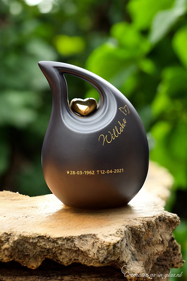 Slanted tear urn in black color with gold heart