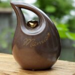 Slanted tear urn in brown color with gold heart
