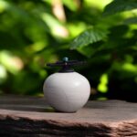 urn raku fired with lid in a cream color