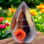 Glass design urn with transparent orange-black ash chamber and image of an orange poppy – suitable for cremation ashes.