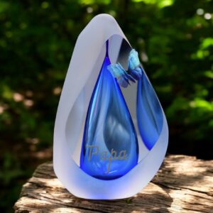 Design urn made of glass with transparent blue ash chamber and space for a short name – suitable for cremation ashes.