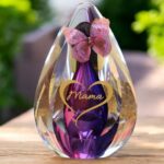 Glass design urn with pink-purple ash chamber and image of a gold-coloured heart in silhouette shape with space for a short name – suitable for cremation ashes.