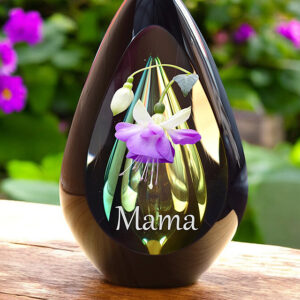 Design urn made of glass with transparent green-yellow ash chamber and image of a fuchsia flower – suitable for cremation ashes.