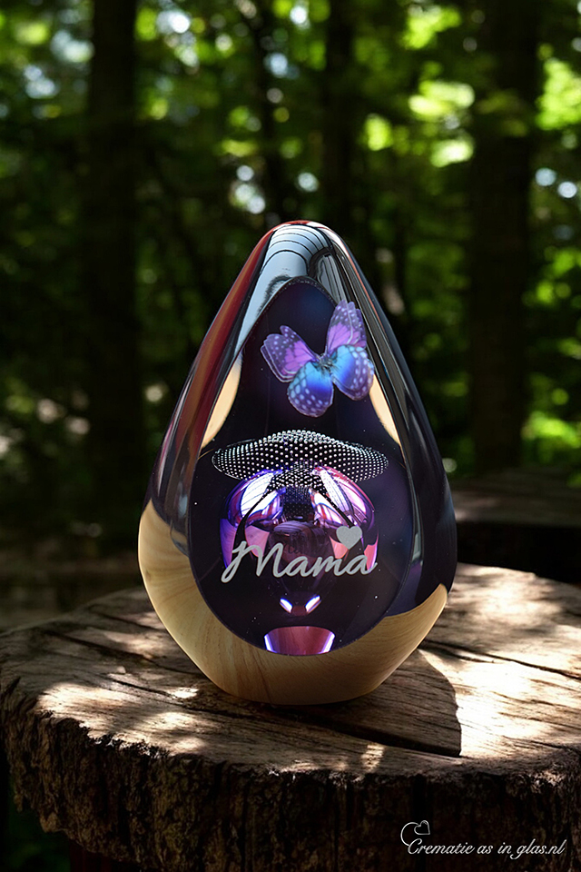 Design urn made of glass with purple-pink ash chamber and air bubbles just above it – suitable for cremation ashes.